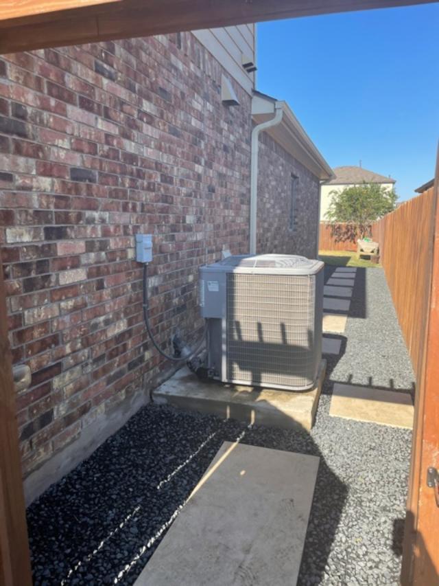 Side yard with stone pavers around AC unit